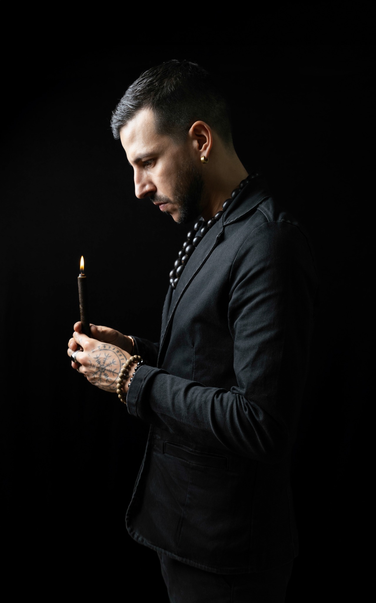 Full portrait of Azazel Qayin with a candle