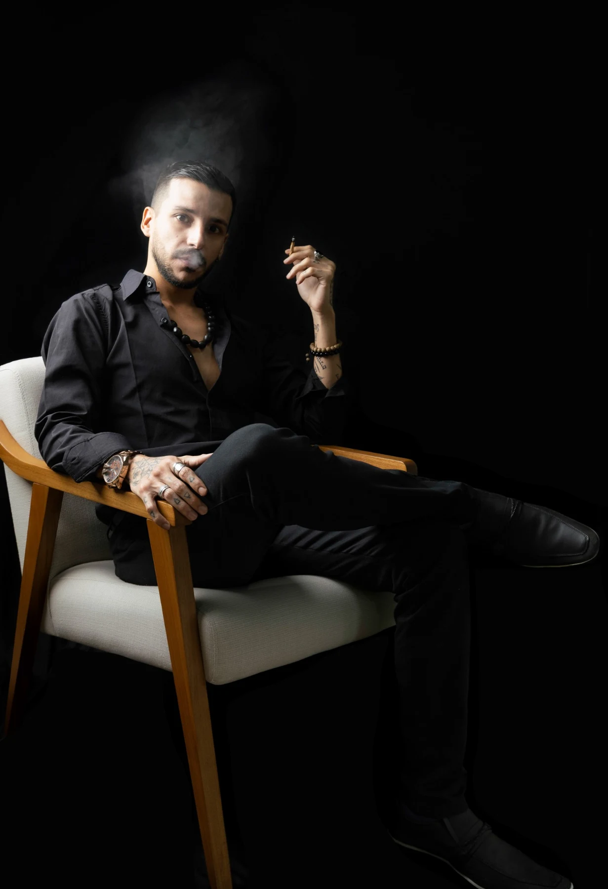 Azazel Qayin seated in his studio